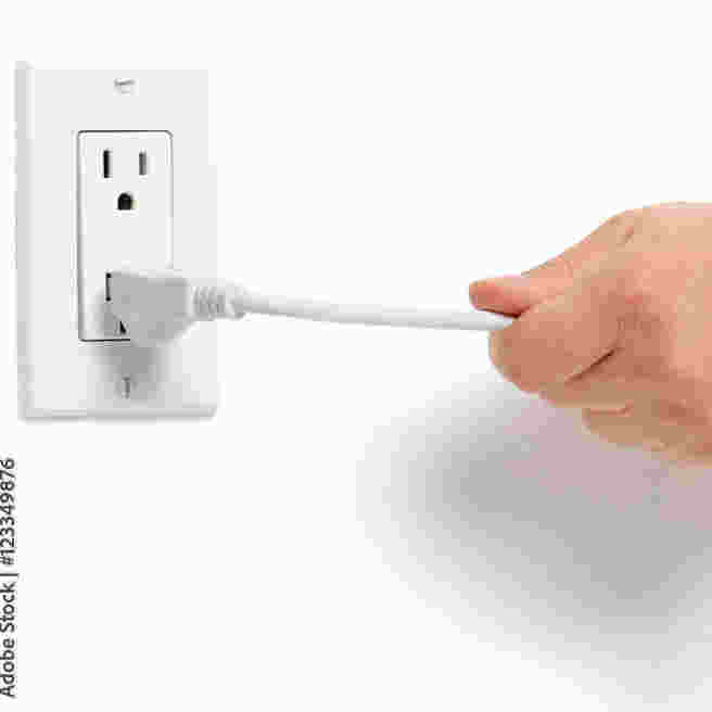 A US power plug being removed from a socket